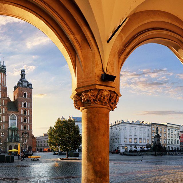 a bridge over water with a city in the background
