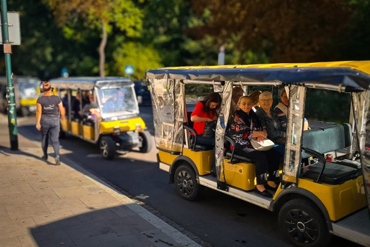 a group of people riding on the back of a truck