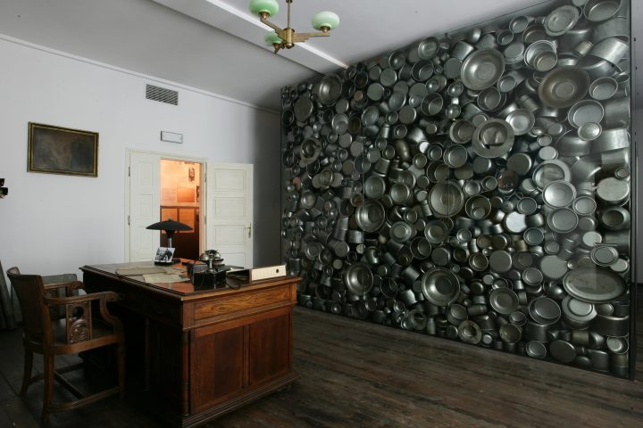 table, chair and a wall full of cans