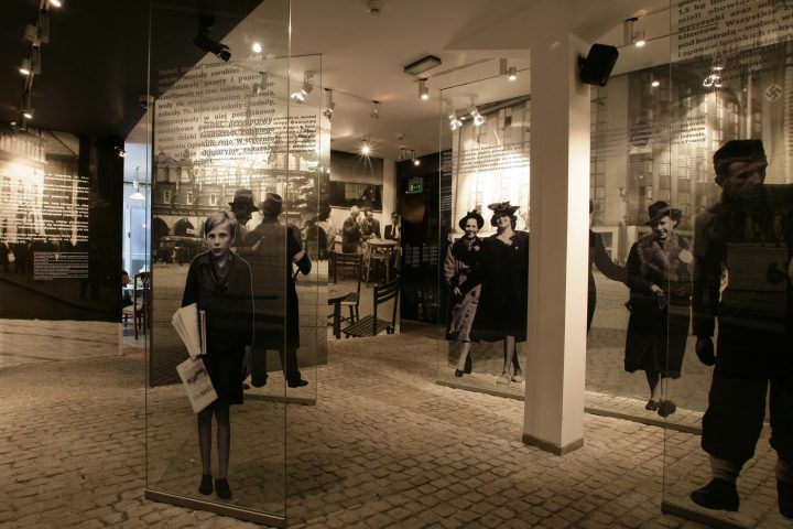 a group of people walking in front of a building