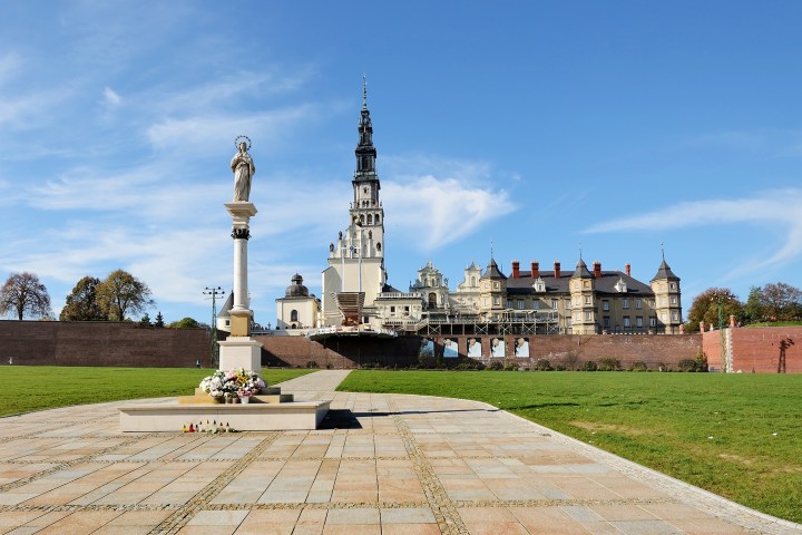 a large clock tower sitting in the grass