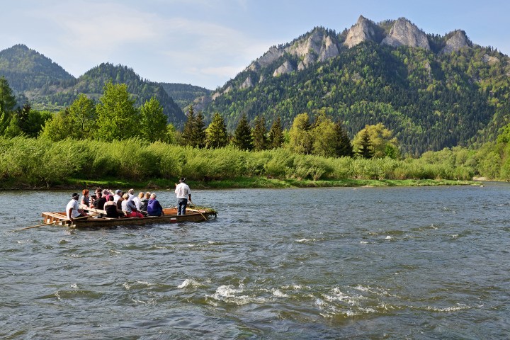 a group of people in a boat on a body of water