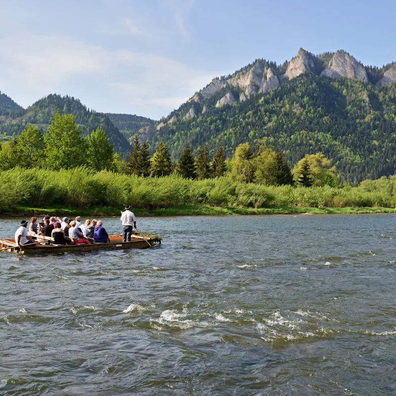 a group of people in a boat on a body of water