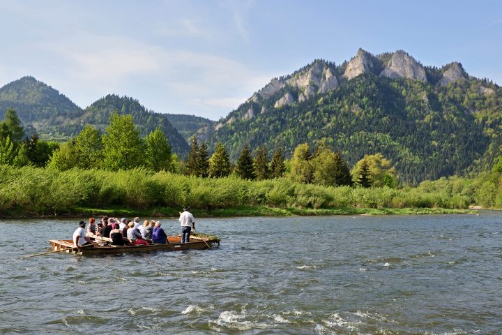 a group of people in a small boat in a body of water