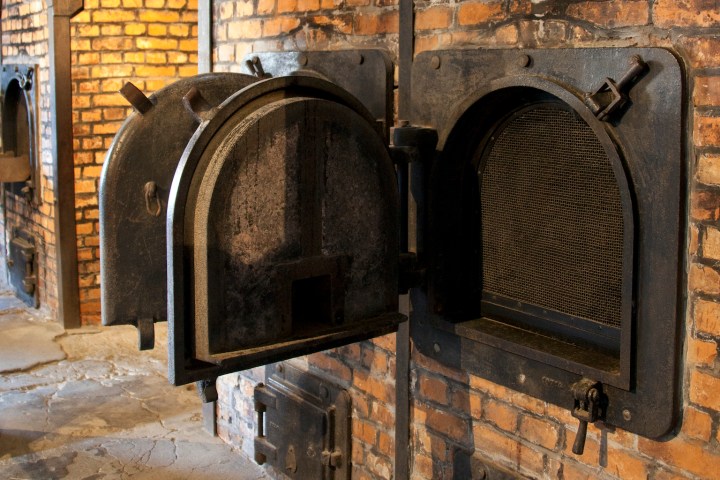 a stone building that has a stove and a brick wall