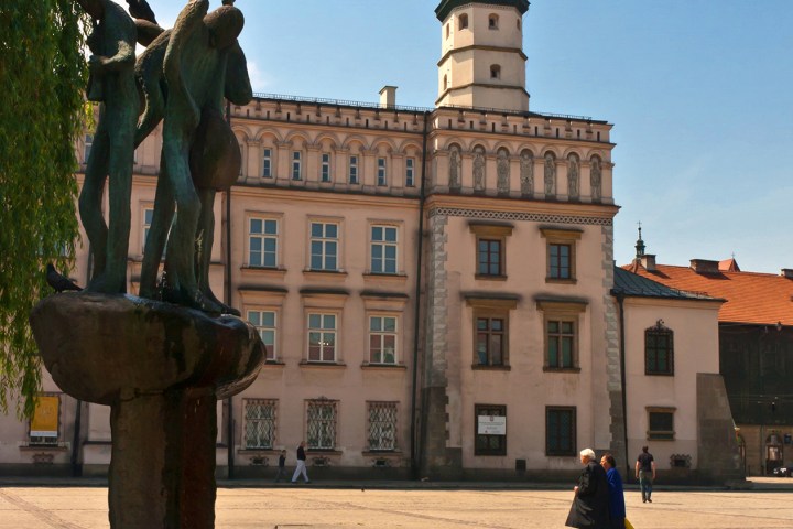 a group of people walking in front of a building