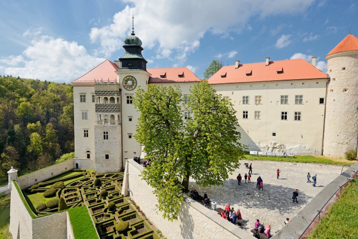 a castle with a clock on the side of a building