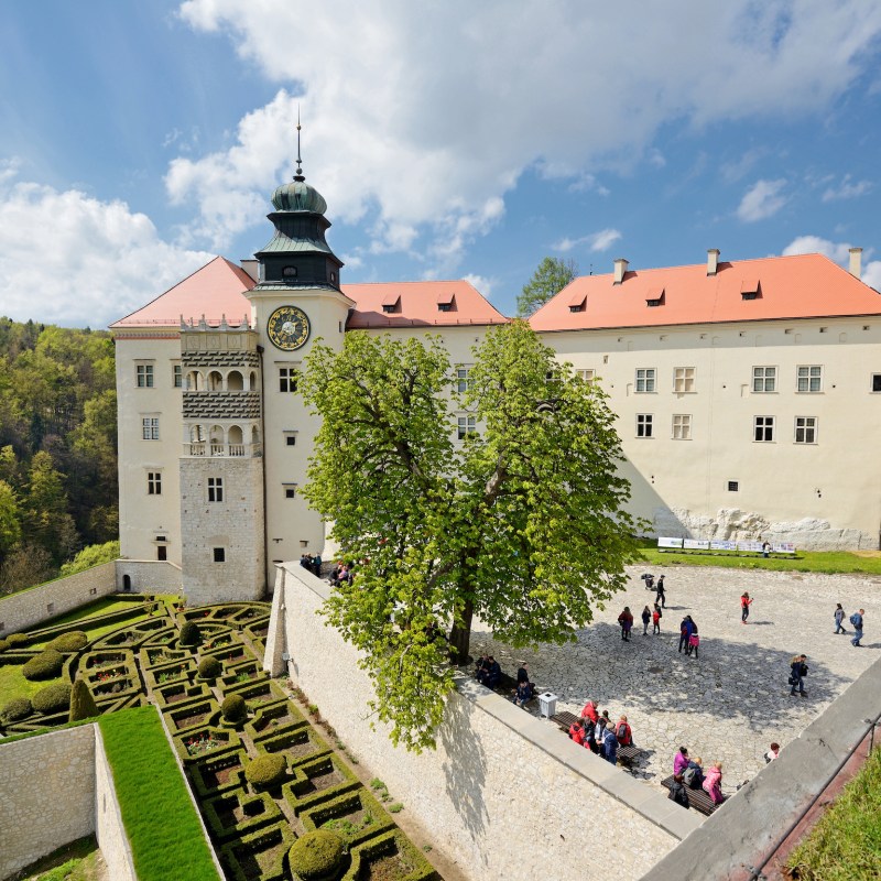 a castle with a clock on the side of a building