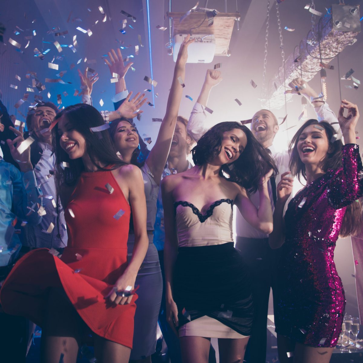 a group of people standing in front of a crowd posing for the camera