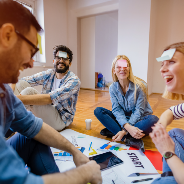 a group of people sitting on a cutting board with a cake