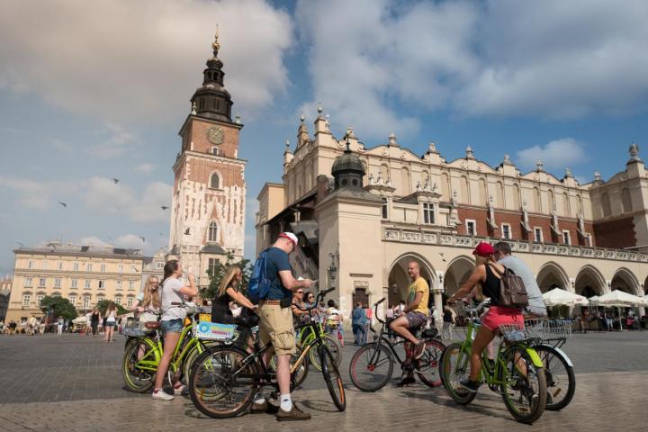a group of people riding on the back of a bicycle
