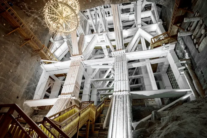 Large underground chamber with wooden walkways and a chandelier.