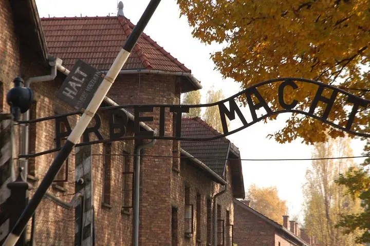 Entrance gate with 'Arbeit Macht Frei' sign at Auschwitz concentration camp.